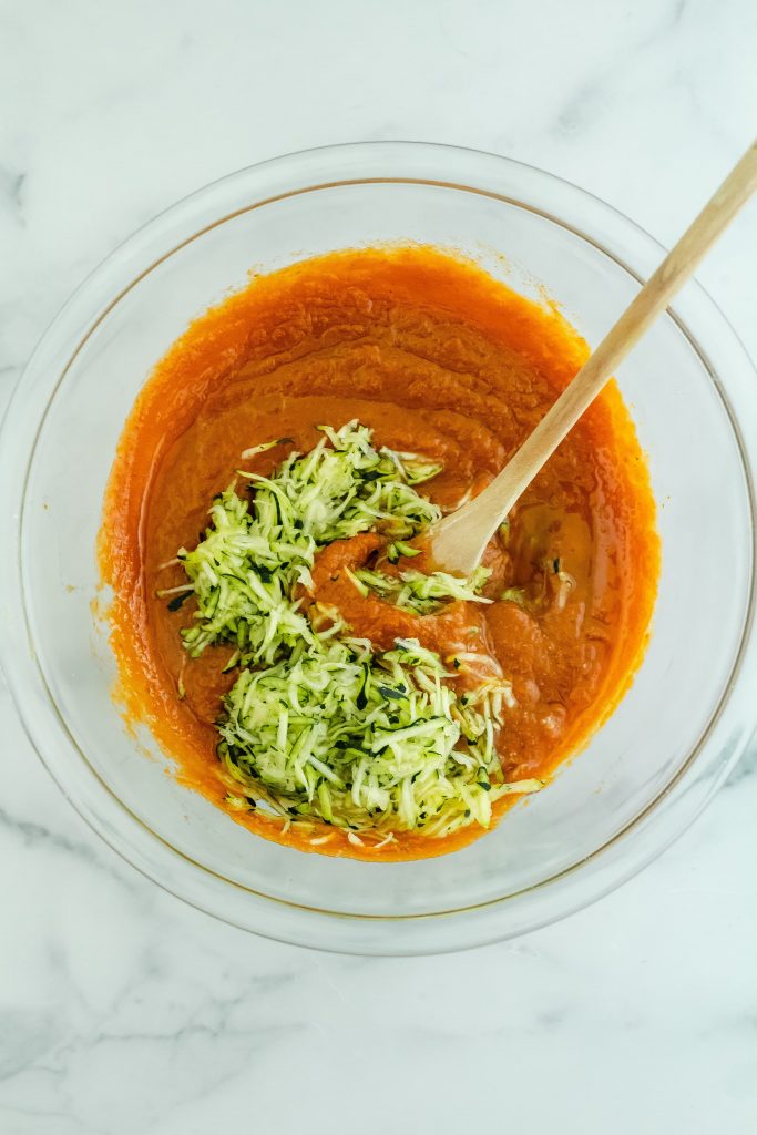 adding zucchini to pumpkin bread batter