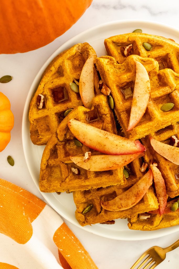 best fluffy whole grain pumpkin waffles with pecans, pumpkin seeds, and cinnamon apples on top