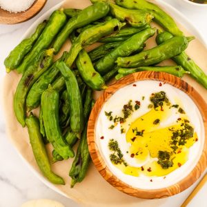 Blistered shishito peppers with herby yogurt sauce