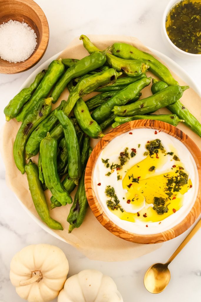 Blistered shishito peppers with herby yogurt sauce