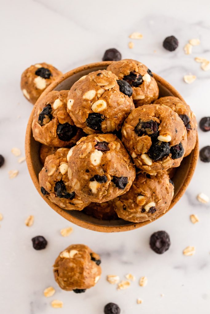 blueberry energy bites with lemon, coconut, oats, almond butter, and white chocolate chips