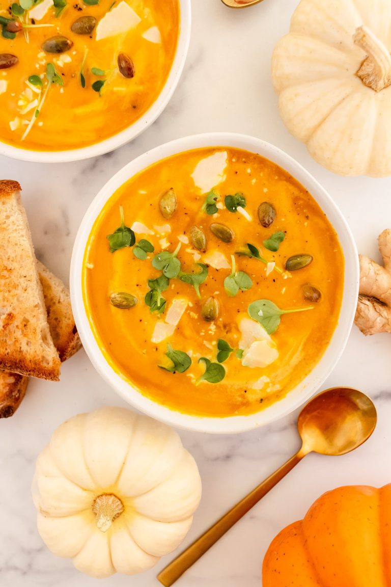 creamy dairy free pumpkin soup topped with toasted pumpkin seeds