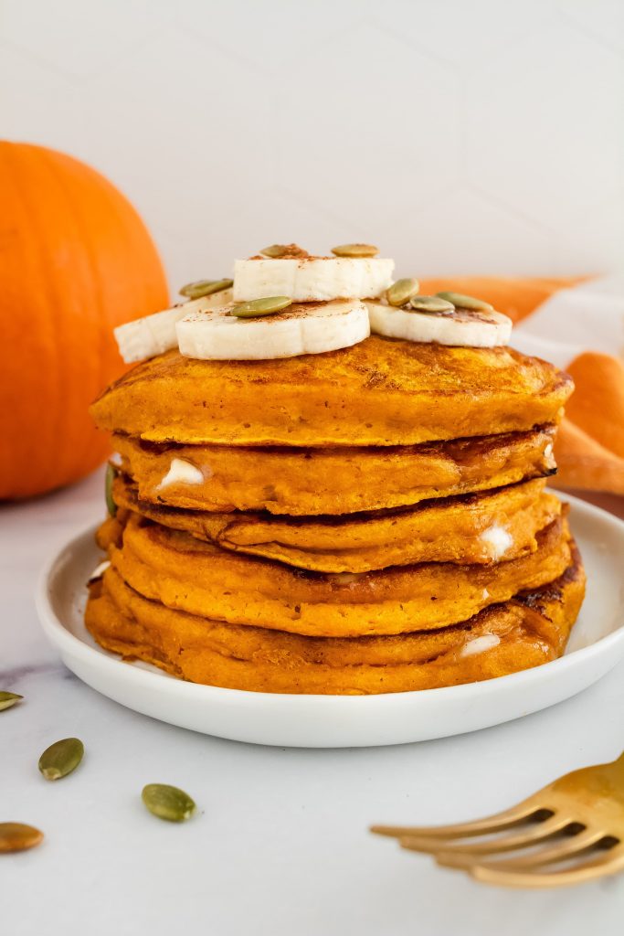 easy pumpkin pancakes with white chocolate chips and sliced banana