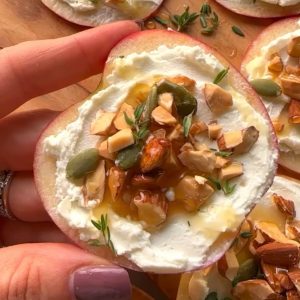 sliced apple appetizer with goat cheese, almonds and honey