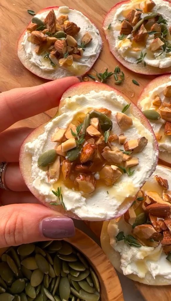 sliced apple appetizer with goat cheese, almonds and honey