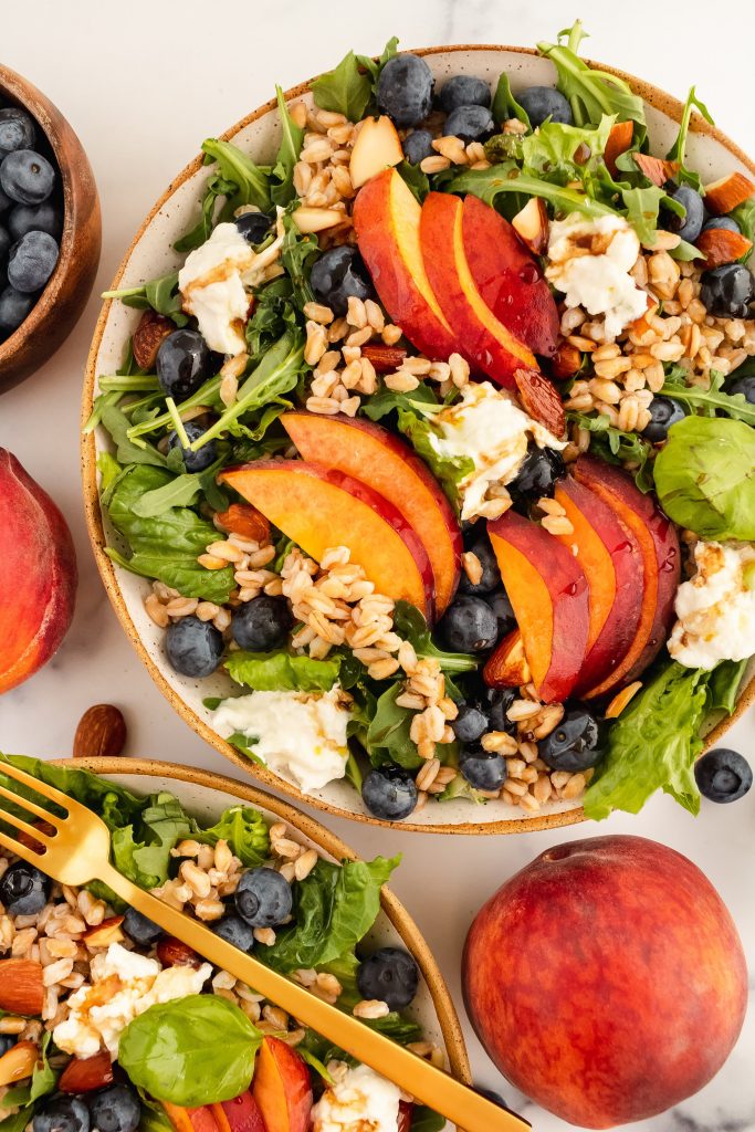 summer salad with blueberries, peaches, burrata, farro, almonds and balsamic vinaigrette