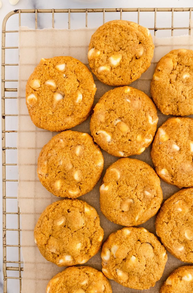 thin and crispy pumpkin cookies with white chocolate chips and macadamia nuts