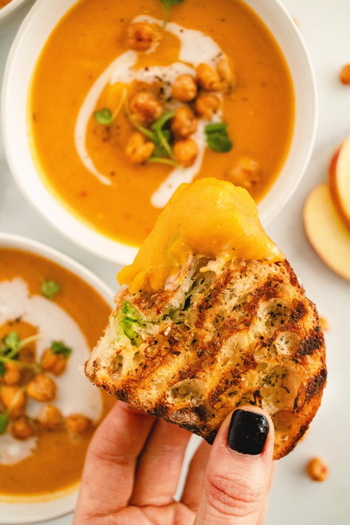 tukery, avocado and cheese panini dipped in creamy dairy free butternut squash soup